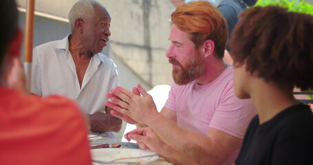 Group of friends and family enjoying a lively outdoor meal, highlighting cheerful connection, casual interactions, and togetherness in a vibrant setting