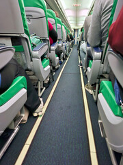 Passengers seated inside of a commercial passenger airplane.