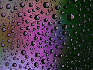 Macro shot of water droplets on blue and green gradient surface