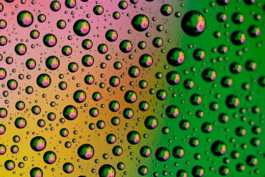 Macro shot of water droplets on blue and green gradient surface