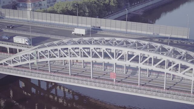 Aerial drone shot of metal bridge and river reflection, D-Log footage