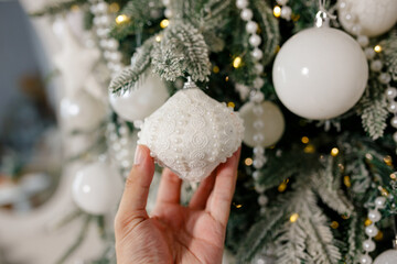 Christmas tree decorations in the interior of a residential building. A Christmas plastic tree is...
