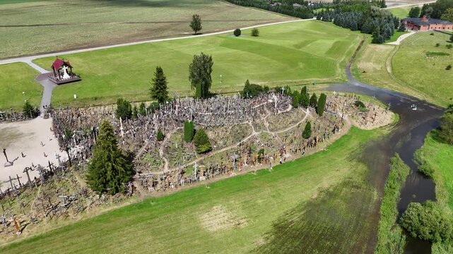 Hill of Crosses, Siauliai, Lithuania &mdash; August 1, 2025: Panoramic aerial footage captured by drone. The scene shows thousands of wooden and metal crosses, walking paths and the surrounding countryside 
