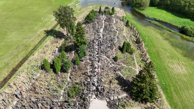 Hill of Crosses, Siauliai, Lithuania &mdash; August 1, 2025: Panoramic aerial footage captured by drone. The scene shows thousands of wooden and metal crosses, walking paths and the surrounding countryside 