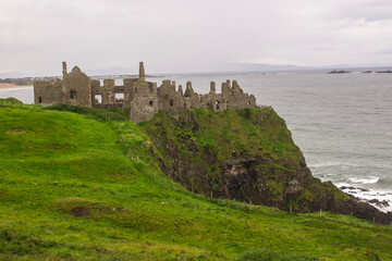 The historic Dunluce Castle ruins near Bushmills on the North Antrim coast in Northern Ireland often used as a film location in period dramas © Michael