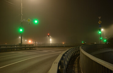 Empty city crossroads at night in foggy winter weather
