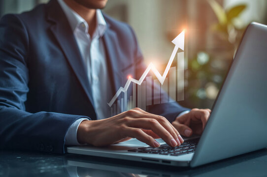 Businessman typing on laptop showing financial growth graph trend