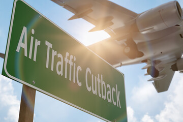 Air Traffic Cutback Green Road Sign with Airplane Above.
