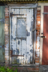 Peeling paint on an old door.
