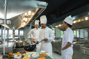professional chefs white uniform work together clean, modern commercial kitchen. focus prepare various dishes surrounded  stainless steel appliances and fresh ingredients. scene high culinary teamwork