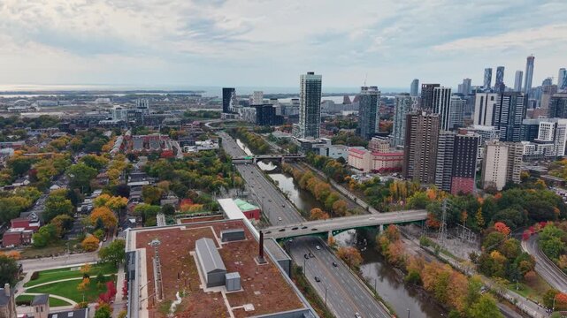 Beautiful drone view of the Don Valley Parkway, Riverdale Park, the Don River and the downtown Toronto skyline looking southwest in autumn, Ontario, Canada. Toronto architecture and skyscrapers.