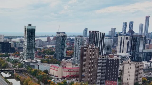 Beautiful drone view of the Don Valley Parkway, Riverdale Park, the Don River and the downtown Toronto skyline looking southwest in autumn, Ontario, Canada. Toronto architecture and skyscrapers.