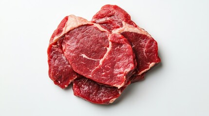 Group of raw beef slices against a white background, ready for cooking.