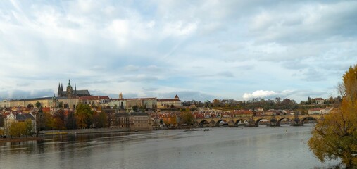 Colourful, autumn panorama of Prague from the river side, in daylight, with the Royal Hill (Hradcany)