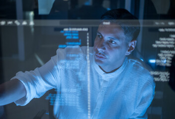 Man team member collaborate on working digital project with code display on transparent screen. image highlight modern teamwork, technology, and innovation digital workspace in dark room.