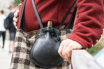 vintage leather water bottle worn over the shoulder
