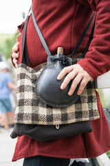 vintage leather water bottle worn over the shoulder
