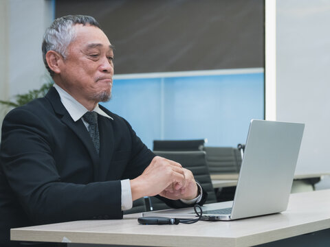 business man in suit analyzing charts and graphs on laptop screen in office setting. image show data visualization such as pie chart and bar graph, representing business analytics and decision-making.