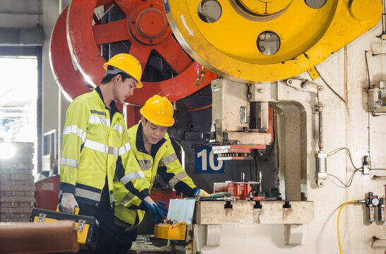 Leader manager professional talk work order staff engineer technician team hardhat uniform safety vest hand holding tool maintenance check inspection measuring product technology in industry factory