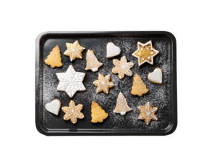 Flatlay of Christmas cookies on baking tray with flour dust, white background