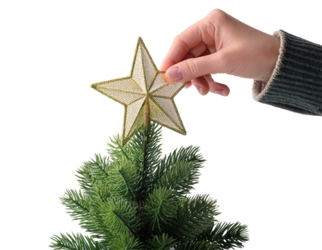 Hand placing star decoration on small artificial tree, white background