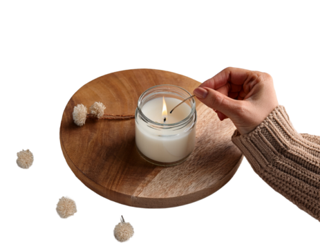 Hands lighting a candle in a cozy minimalist setup, white background