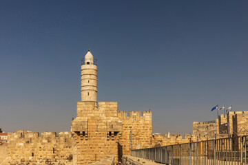 Obraz premium jerusalem, Israel, 9 October 2025, The historical tower of david (phasa'el tower) and the old city walls made of jerusalem stone, standing against a clear, bright blue sky in the daytime.