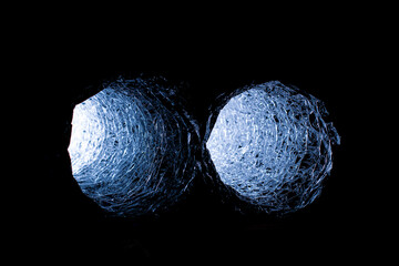 A close-up of a flexible air duct letting sunlight into a dark room, a problem with indoor ventilation