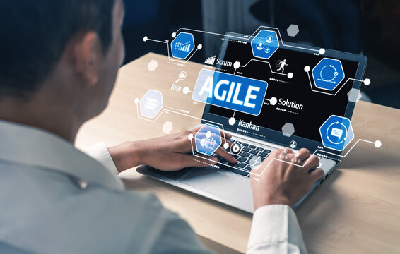 A professional interacts with a laptop displaying Agile tools, illustrating key concepts like Scrum and Kanban, essential for optimizing project workflow and enhancing collaboration. Tessel