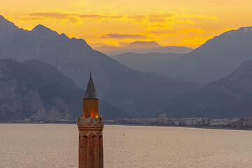 Fluted Minaret (yivli Minare) with sunset over the mountains, Antalya Turkiye