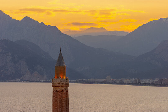Fluted Minaret (yivli Minare) with sunset over the mountains, Antalya Turkiye
