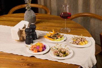 An Elegant Dining Setup Complete with an Array of Assorted Dishes and Wine Selection