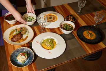 Artfully Plated Gourmet Dishes Beautifully Arranged on a Wooden Table for Enjoying