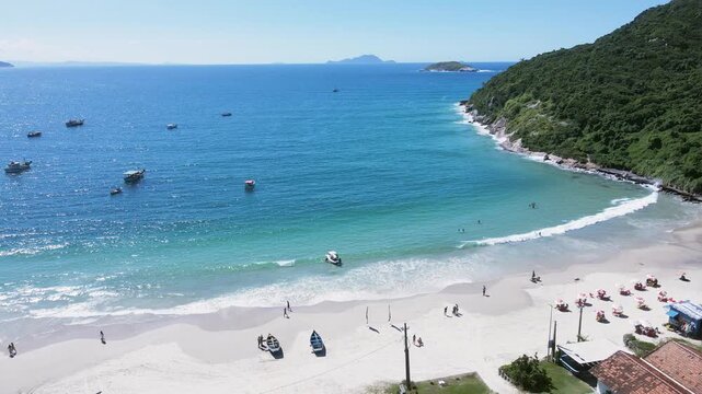 Aerial view of Ingleses beach in Florian&oacute;polis, Santa Catarina. Fishermen's corner with fishing boats at sea, dune banks and Ingleses hill, deep blue sea.