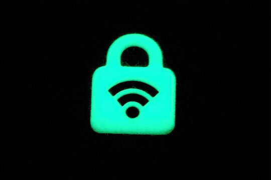 Luminescent padlock symbolizing digital security and data protection in online environments illuminated against a black backdrop with a modern visual ethos captured with clarity