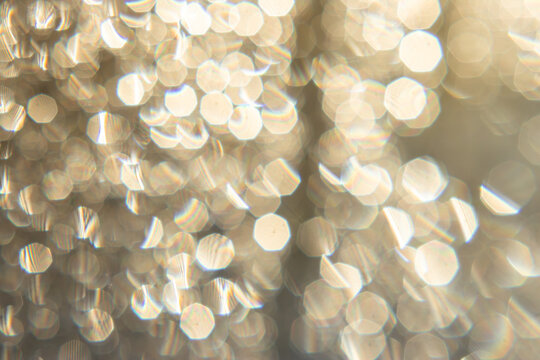 Macro close-up of golden sequins and glitter texture, sparkling background with bokeh effect, abstract festive surface, perfect for copy space, design, holiday projects. - Powered by Adobe