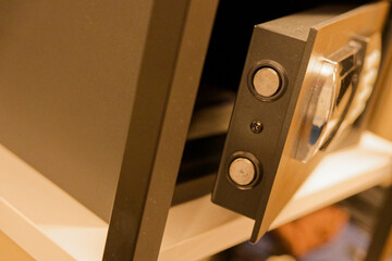 Partly open hotel room safe with keypad and hinge view
