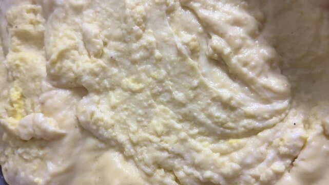 A person smoothing out spreadable cream. Homemade cooking.