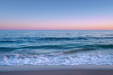 Obraz premium A serene beach scene with soft waves in sunset