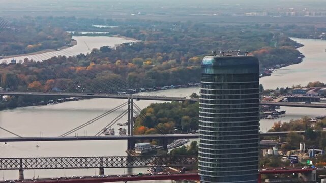 Aerial capture of Ada bridge, a modern road bridge over the Sava river in Belgrade, Srbija. Serbia. Captivating aerial footage showcase a epic panorama of Belgrade at sunset. 