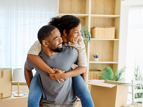 Portrait of a young couple unpacking, moving in and relocation to a new apartment, happy young couple family new beginning