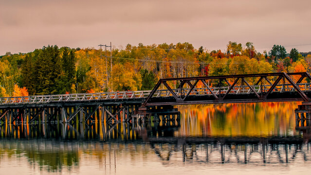 Algonquin Park in autumn bridge and its reflection