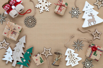 top down view of various holiday season ornaments on brown paper.