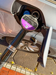 Car refueling at pump with diesel nozzle inserted firmly © Holger