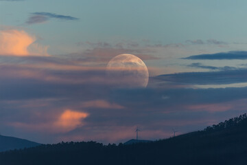 Photographing big waves, birds flying at sea, and the almost full moon!