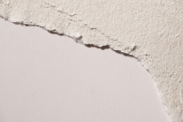 Torn Edge of Textured White Handmade Paper on Smooth Sheet