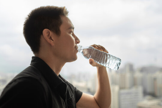 Man Drinking Water from Bottle, Hydration and Healthy Lifestyle, Young Man Staying Hydrated, Wellness and Daily Self-Care
