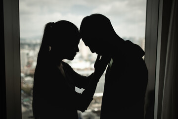A woman gently comforting a sad man during a difficult emotional moment, symbolizing support,...