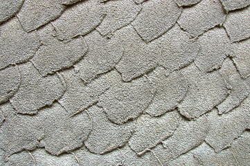 Gray textured surface with layered leaf-like overlapping pattern