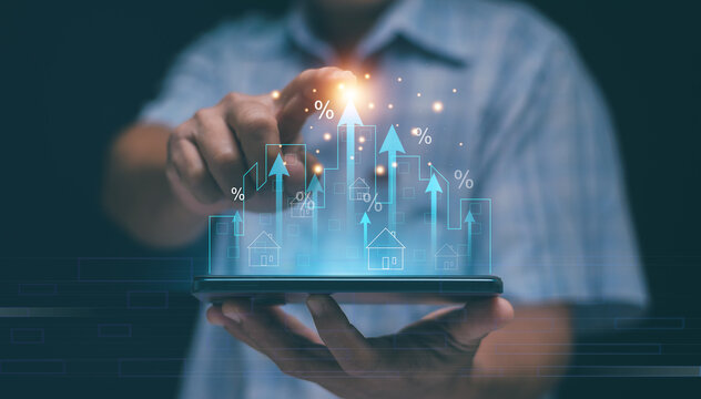 Real estate growth and financial technology concept. Hand holding smartphone with holographic buildings and upward arrows. Investment, property market, digital economy and percentage rate increase.